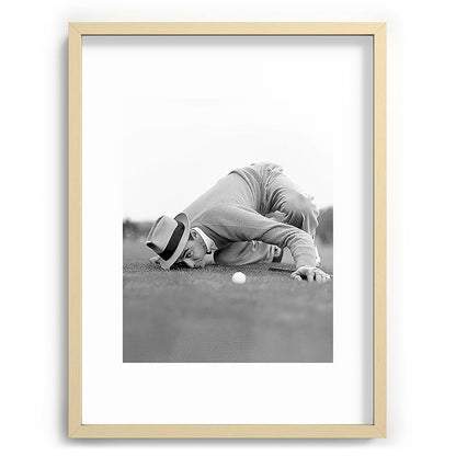 Eye to the ground on the 18th hole; golfing man eyes ball to measure distance to hole vintage black and white portrait photograph - photography - photographs poster Framed Art Print Gallery Image 100